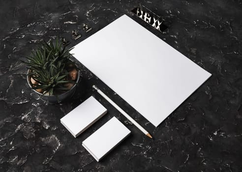 Photo of blank stationery set on black plaster background. Stationery template for branding identity for designers.