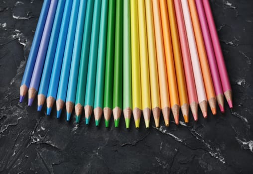 Colored pencil collection on black plaster background