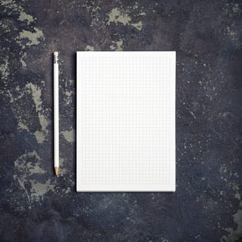 Copybook and pencil on concrete background. Branding stationery mockup. Blank objects for placing your design. Top view. Flat lay.