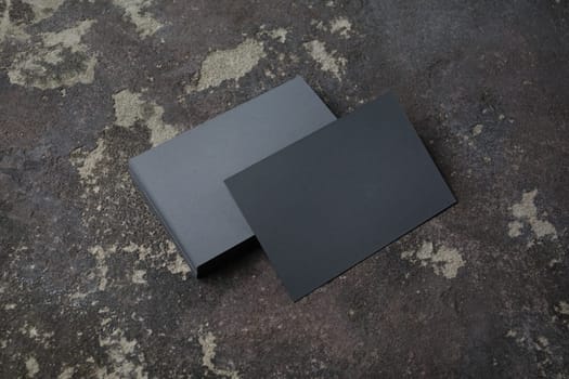 Photo of blank gray business cards on concrete background. Template for ID. Mock-up for branding identity.