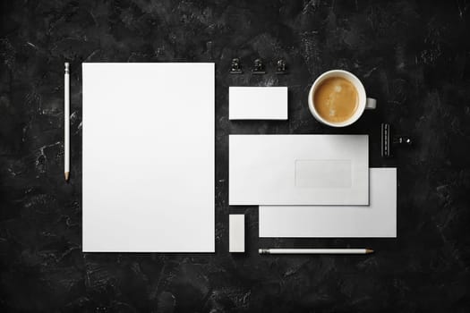 Blank corporate identity set on black plaster background. Mockup for design presentations and portfolios. Top view. Flat lay.