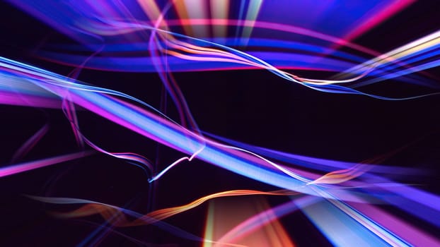Colorful fiber strings in motion against black background