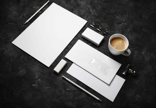Blank corporate stationery set on black plaster background. Branding mock up.