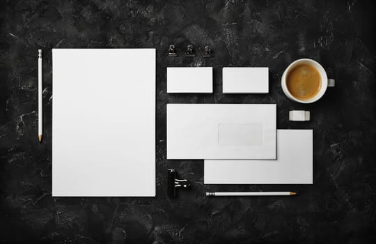 Blank stationery set on black plaster background. Corporate identity template. Responsive design mockup. Top view. Flat lay.