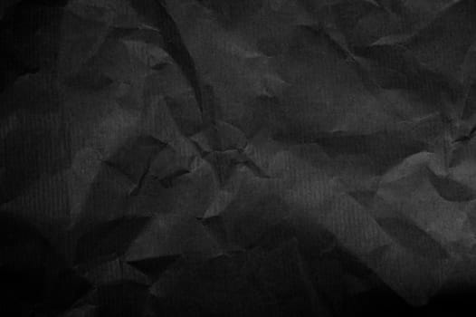 Wrinkled black paper background texture