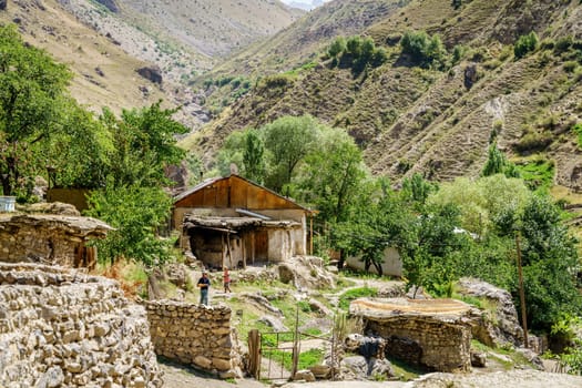 August 26, 2016, Margib village, Tajikistan: A young woman carries freshly baked traditional Tajik bread in a remote mountain village in Tajikistan