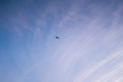 Little white plane on a background of the blue summer sky.