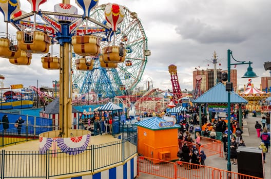 Different Rides at Luna Park Amusement Park, Coney island, aerial view, Brooklyn, crowd of People at Jewish National Day, New York City during winter day with cloudy sky, horizontal