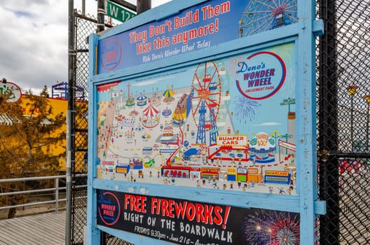 Luna Park Amusement Park, Park Map Poster attached to a Fence at Coney island, Brooklyn, New York City during winter day with cloudy sky, horizontal