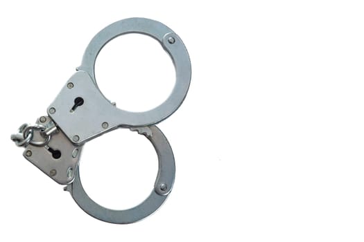 Metal handcuffs on a white isolated background, copy space. High quality photo