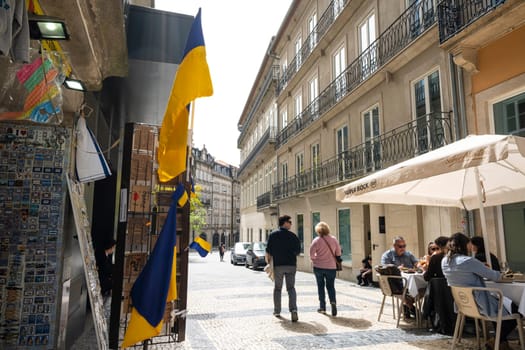 Porto, Portugal. March 2022. Ukrainian flags displayed in a small shop in the city center