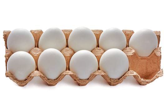 Nine white eggs on a cardboard stand on a white isolated background, copy space. High quality photo