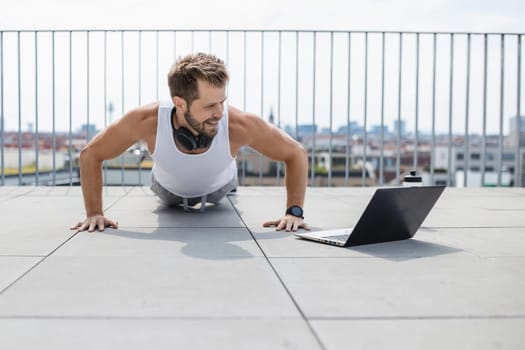 Handsome young man training and working out outdoors