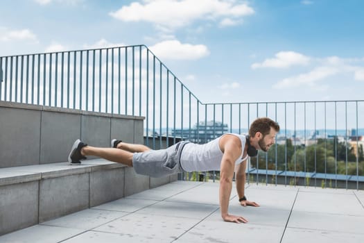 Handsome young man training and working out outdoors