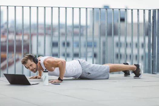 Handsome young man training and working out outdoors