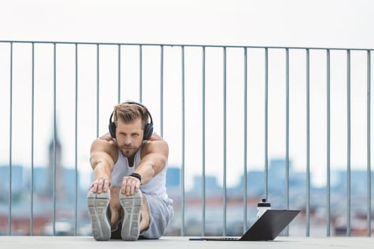 Handsome young man training and working out outdoors