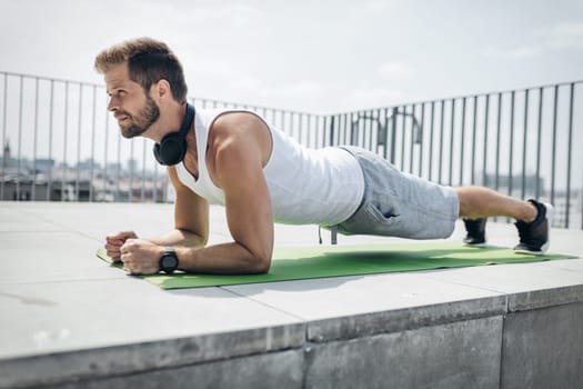 Handsome young man training and working out outdoors