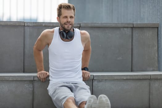 Handsome young man training and working out outdoors
