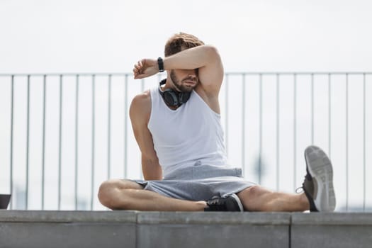 Handsome young man training and working out outdoors