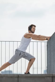 Handsome young man training and working out outdoors