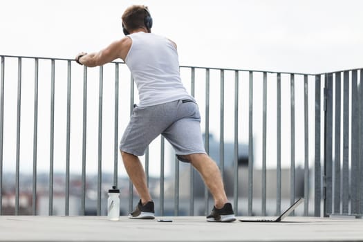 Handsome young man training and working out outdoors