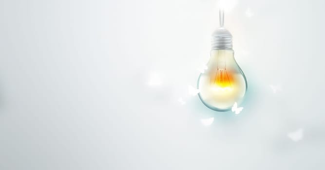 Luminous Bulb And Butterflies Flying On Light