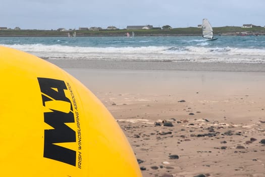 giant  Irish windsurfing association yellow buoy on a beach in the wild atlantic way