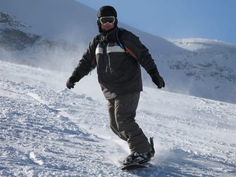 snowboarder on a ski slope under a blue sky
