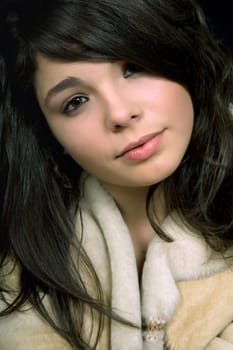 young beautiful brunette portrait against black background