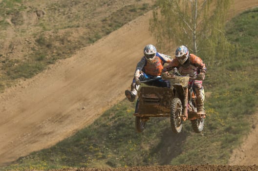 MOHELNICE, CZECH REPUBLIC - APRIL 25. High jump of sodecars racers in the "International Championship of Czech Republic in sidecarcross 2015"" on April 25. 2015 in Mohelnice, Czech Republic."