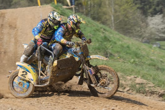 MOHELNICE, CZECH REPUBLIC - APRIL 25. Two riders of sidecar in the race named "International Championship of Czech Republic in sidecarcross 2015"" on April 25. 2015 in Mohelnice."