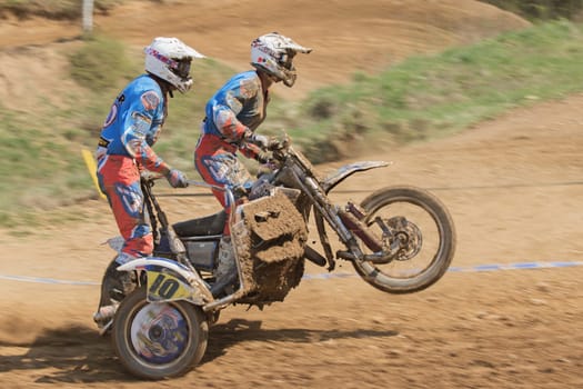 MOHELNICE, CZECH REPUBLIC - APRIL 25. Dynamic shot of racers standing on a sidecar in the "International Championship of Czech Republic in sidecarcross 2015"" on April 25. 2015 in Mohelnice."