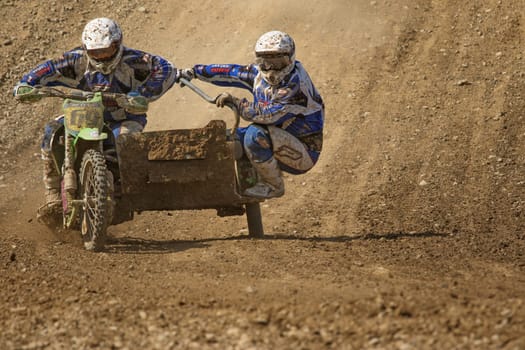 MOHELNICE, CZECH REPUBLIC - APRIL 25. Two racers are ahead of the turn  in the "International Championship of Czech Republic in sidecarcross 2015"" on April 25. 2015 in Mohelnice."