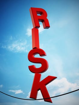 RISK letters standing on the black rope against blue sky