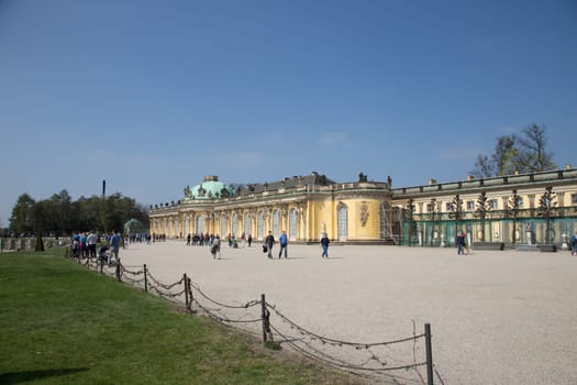 Sans Souci Palace in Potsdam with passers-by and tourists
