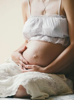 Pregnant woman holding her belly