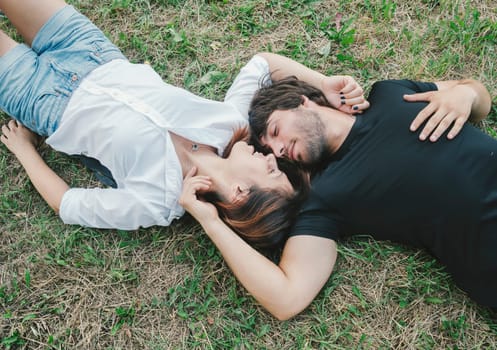 Happy couple lying in the grass