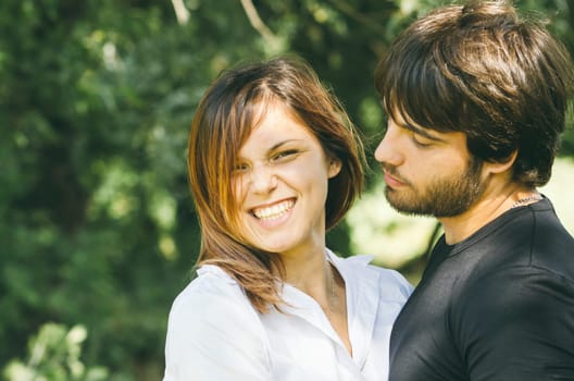 Happy couple hugging in nature