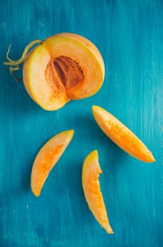 Melon slices on rustic blue background