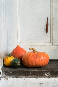 Pumpkins on the rustic wooden doorstep. Texture added.