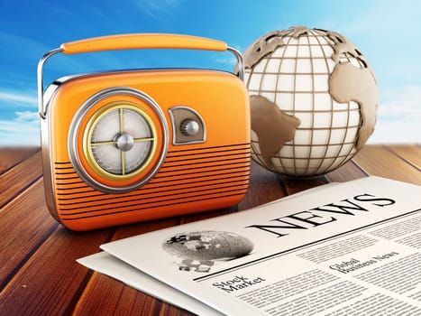 Vintage radio, newspaper and globe standing on wooden planks