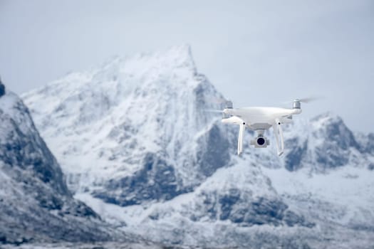 Quadcopter drone with digital camera in mountains