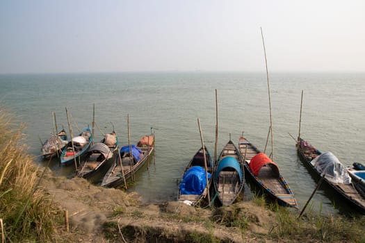 Beautiful view of Traditional Some wooden fishing boat on Padma river by Bangladesh. Natural Landscape view