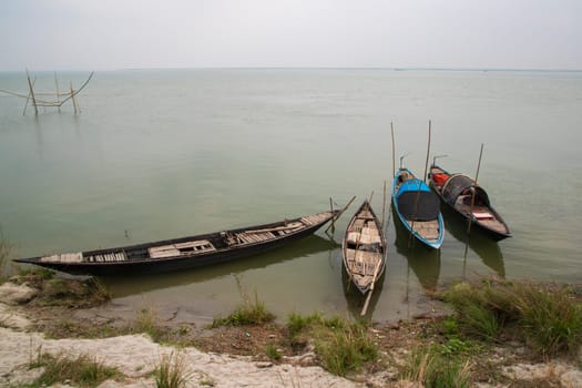 Beautiful Landscape View of Some wooden fishing boats on the bank of the Padma river in Bangladesh