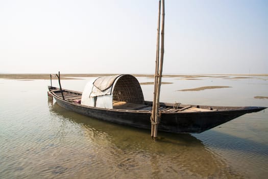 A Wooden Fishing Boat in Padma River by Bangladesh. Beautiful Landscape View