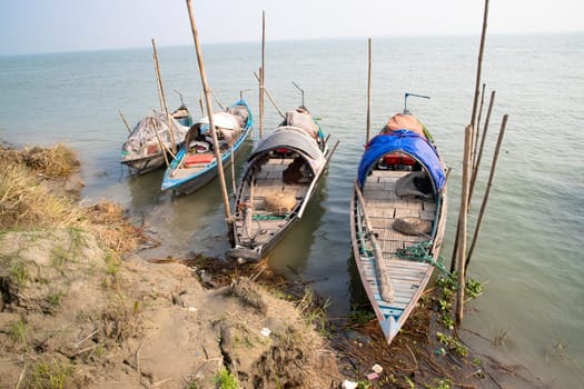 Beautiful view of Traditional Some wooden fishing boat on Padma river by Bangladesh. Natural Landscape view