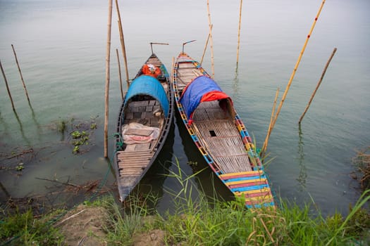 Beautiful Landscape View of Two wooden fishing boats on the bank of the Padma river in Bangladesh