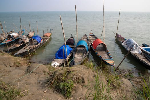 Beautiful view of Traditional Some wooden fishing boat on Padma river by Bangladesh. Natural Landscape view