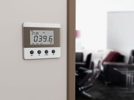 Wall mounted energy meter beside the room entrance.