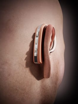 Ear aid or hearing aid on man's ear